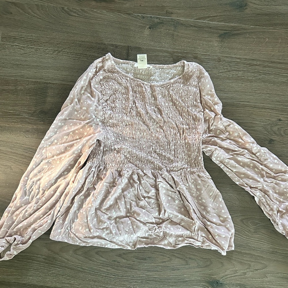 Light pink with white dots. Size small. Delicate washed and dried.